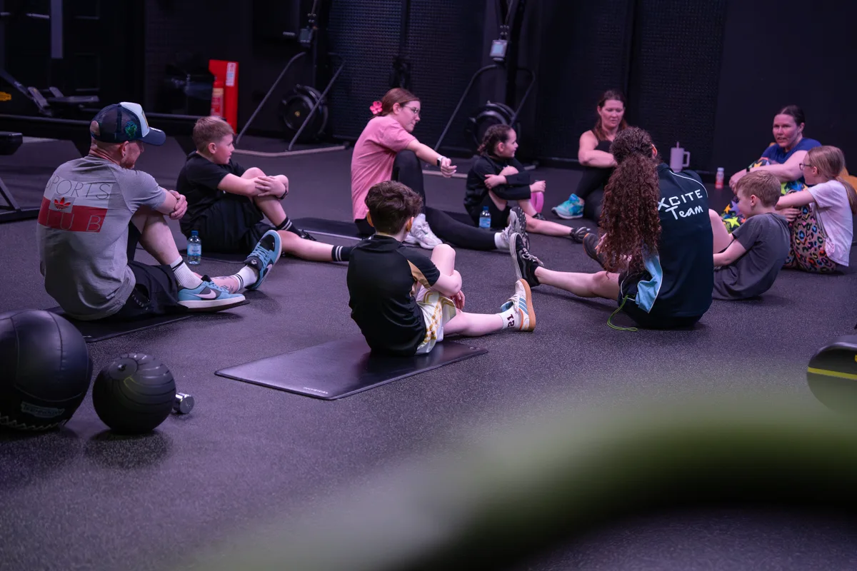 Kids & Adults exercising together.